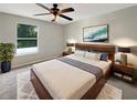 Well-lit main bedroom featuring neutral decor and a ceiling fan at 4209 Sw 33Rd St, Ocala, FL 34474