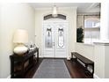 Bright entryway features decorative glass doors, hardwood floors, and stylish accents at 436 Skyview Pl, Chuluota, FL 32766
