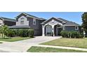 Charming home with a paved driveway, manicured lawn, and lovely landscaping at 436 Skyview Pl, Chuluota, FL 32766