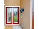 Inviting entryway features a decorative glass door and stylish wall sconce, perfect for welcoming guests at 447 Kehoe Blvd, Orlando, FL 32825