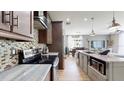 Modern kitchen with granite countertops, stainless steel appliances, and an open layout leading to the dining area at 447 Kehoe Blvd, Orlando, FL 32825