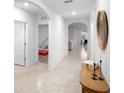 Bright hallway featuring arched doorways and modern decor at 522 Anne St, Deland, FL 32724