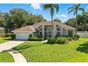 Charming single-story home featuring manicured landscaping, neutral paint, and an attached two-car garage at 7819 Canyon Lake Cir, Orlando, FL 32835