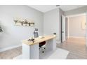 Cozy home office with a stylish desk, comfortable chair, airplane art, and warm decor creates an inspiring workspace at 977 Talon Pl, Winter Springs, FL 32708