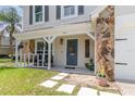 Charming front porch with seating, stone pillars, and a welcoming entrance to the home at 1033 Mccully Ct, Oviedo, FL 32765