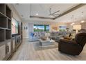 Open-concept living room with stylish furniture, wood floors, and abundant natural light at 1104 Sawgrass Dr, Winter Haven, FL 33884