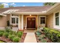 Inviting home entrance with double doors and charming landscaping, creating a warm welcome at 1165 Baltic Ln, Winter Springs, FL 32708