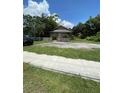 Cozy single-story home with a gravel driveway and a charming white picket fence at 1307 Mabbette St, Kissimmee, FL 34741