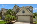 Beautiful home showcasing manicured lawns, a two-car garage, and mature palm trees, creating a picturesque curb appeal at 1509 Cedar Lake Dr, Orlando, FL 32824