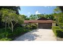 A well-maintained house with a long driveway leading to a two-car garage at 1509 Huntington St, Deltona, FL 32725