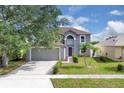 Two-story home with landscaped lawn and attached two-car garage at 16053 Wilkinson Dr, Clermont, FL 34714