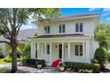Stunning two-story home featuring red tile roof, classic white pillars, and manicured landscaping at 1636 Hanks Ave, Orlando, FL 32814