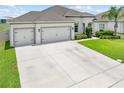 A beautiful one-story home with well-manicured landscaping and a spacious three-car garage at 1789 Chatsworth Cir, St Cloud, FL 34771