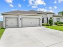 A beautiful one-story home with well-manicured landscaping and a spacious three-car garage at 1789 Chatsworth Cir, St Cloud, FL 34771