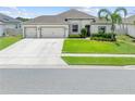 Charming single-story home with a well-manicured lawn and a spacious three-car garage at 1789 Chatsworth Cir, St Cloud, FL 34771