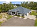 Sprawling one-story home featuring a well-manicured lawn and elegant contrasting trim at 18826 Reynolds Pkwy, Orlando, FL 32833