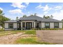 Elegant single-story home showcases a lush front yard, double door entry and well maintained landscape at 18826 Reynolds Pkwy, Orlando, FL 32833