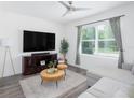 Cozy living room with a comfortable sectional sofa, large TV, and plenty of natural light at 193 E Warren Ave, Longwood, FL 32750
