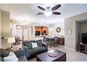 Comfortable living room with tile floors, ceiling fan, and views of the kitchen and dining area at 1941 Sunset Palm Dr, Apopka, FL 32712
