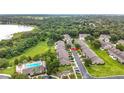 Aerial view of community, highlighting lush landscaping, pool and proximity to lake at 2092 Switch Grass Cir, Ocoee, FL 34761