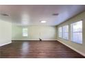 Bright living room featuring hardwood floors, recessed lighting, and large windows at 2183 Leather Fern Dr, Ocoee, FL 34761