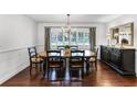 Elegant dining room featuring a wood table with seating for six, hardwood floors, and wainscoting at 2527 Shrewsbury Rd, Orlando, FL 32803