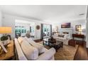 Bright and airy living room featuring hardwood floors, white sofas, a fireplace, and french doors at 2527 Shrewsbury Rd, Orlando, FL 32803