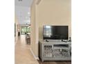 Open-concept living room with tile flooring, neutral walls, and a seamless transition to dining area at 2759 Purple Meadow Ct, Minneola, FL 34715