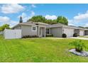 Beautifully landscaped front yard with a well-kept lawn and matching neighboring homes at 308 Clearwater Ln, Poinciana, FL 34759