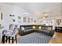 Bright living room featuring a large leather sectional, vaulted ceilings, and modern decor at 3415 Celena Cir, St Cloud, FL 34769
