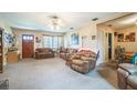 Comfortable living room featuring plush carpeting, ceiling fan, and traditional furnishings at 426 Illinois Ave, St Cloud, FL 34769