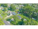 Overhead shot of a neighborhood with houses, green lawns, and mature trees, showcasing the community at 4911 Ne 7Th St, Ocala, FL 34470