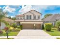 Charming two-story home boasts a well-manicured lawn, lush landscaping, and a convenient two-car garage at 561 Gunston Ct, Davenport, FL 33837