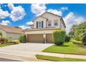 A well-maintained home with a spacious driveway and manicured landscaping on a sunny day at 561 Gunston Ct, Davenport, FL 33837