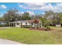 Single-story home featuring a large front yard and landscaping at 7330 Canal Dr, Sanford, FL 32771