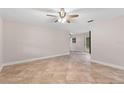 Spacious living room with tile flooring, ceiling fan, and ample natural light at 7330 Canal Dr, Sanford, FL 32771