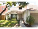 Inviting front entrance with walkway, small palms, and manicured landscaping at 7939 Winter Song Dr, Orlando, FL 32825