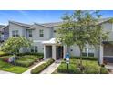 Charming townhome featuring a well-maintained exterior, lush greenery, and convenient accessibility features at 850 Pebble Beach Dr, Davenport, FL 33896