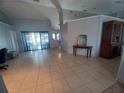 Spacious living room featuring tiled floors, bright natural lighting, and a seamless open-concept design at 8509 Sw 136Th Loop, Ocala, FL 34473