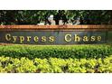 Entrance sign to Cypress Chase community with manicured shrubs at 9003 Pecky Cypress Way, Orlando, FL 32836