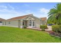 Well-manicured lawn leads to a lovely single-story home with lush landscaping at 9003 Pecky Cypress Way, Orlando, FL 32836