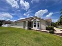 Well-maintained home with lush green lawn and neat landscaping on a sunny day with blue skies and clouds at 9003 Pecky Cypress Way, Orlando, FL 32836