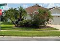 Well-maintained corner lot with mature landscaping, including palm trees at 9003 Pecky Cypress Way, Orlando, FL 32836