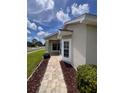 Inviting entrance with a brick walkway, bay window, and manicured shrubs at 9003 Pecky Cypress Way, Orlando, FL 32836