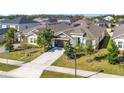 An elevated view of a well-maintained, single-Gathering home with a neatly manicured lawn and landscaping at 913 Sabal Breeze Ln, Apopka, FL 32703