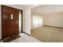 Inviting foyer with tile flooring and a view into the living room at 9206 Everwood St, Orlando, FL 32825