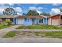 Charming single-Gathering home showcasing a light blue exterior with an attached one-car garage and cozy front yard at 978 Calanda Ave, Orlando, FL 32807