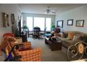 Cozy living room featuring neutral tones, large windows for natural light, and comfortable seating arrangements at 1031 S Hiawassee Rd # 2514, Orlando, FL 32835