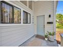Close-up of front door with modern hardware, house number, and stylish potted plants at 1310 Oregon St, Orlando, FL 32803
