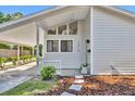 Inviting home entrance featuring a covered carport and meticulously landscaped front yard at 1310 Oregon St, Orlando, FL 32803